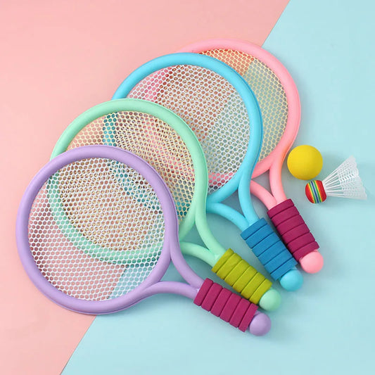 Set of pastel kids rackets with ball and shuttlecock on a colourful background